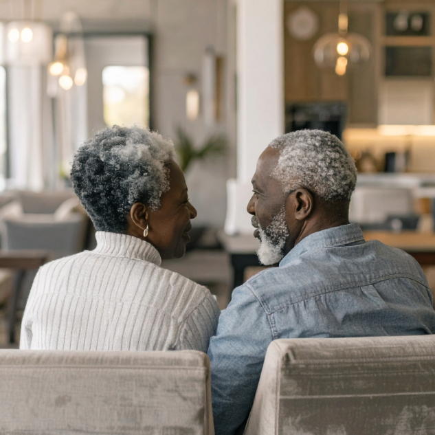 A couple seated together indoors